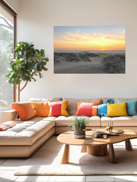 Modern living room with a sectional sofa, colorful pillows, and a canvas print of a beach dunes sunset on the wall.