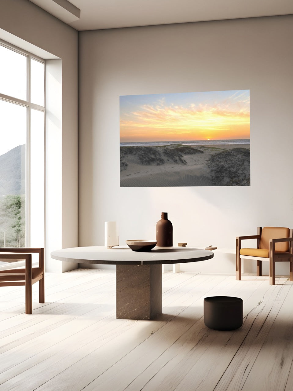 Modern living room with a large canvas print of a beach dunes sunset, wooden furniture, and a vase on a table.