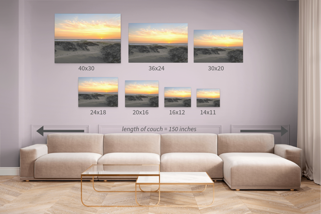 Living room with a beige sectional sofa showing different sizes of a canvas print of a beach dunes sunset