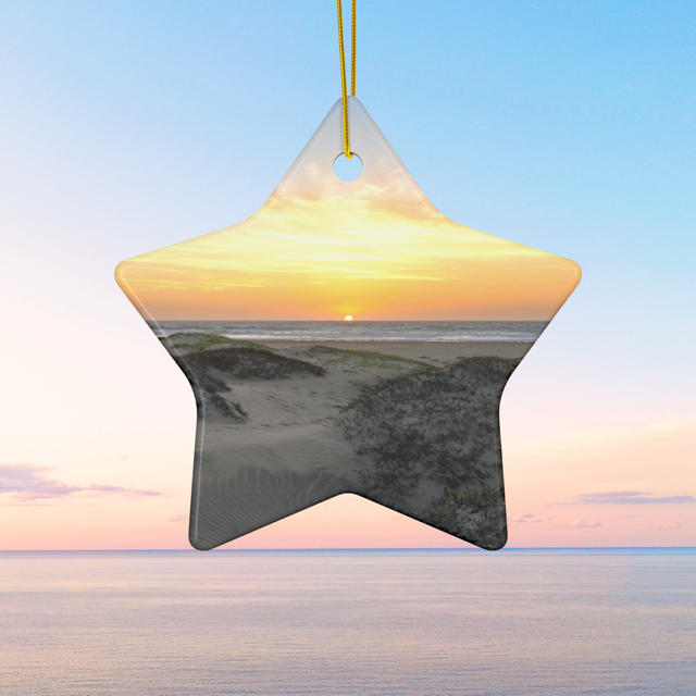 Star shaped ceramic Christmas ornament featuring an original photograph of a sunset over coastal sand dunes