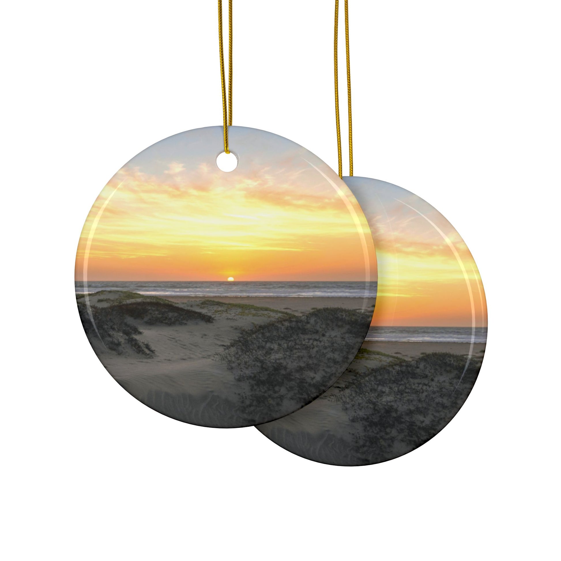 Front and back side ofvcircular ceramic ornaments with a sunset over the ocean and beach dunes.