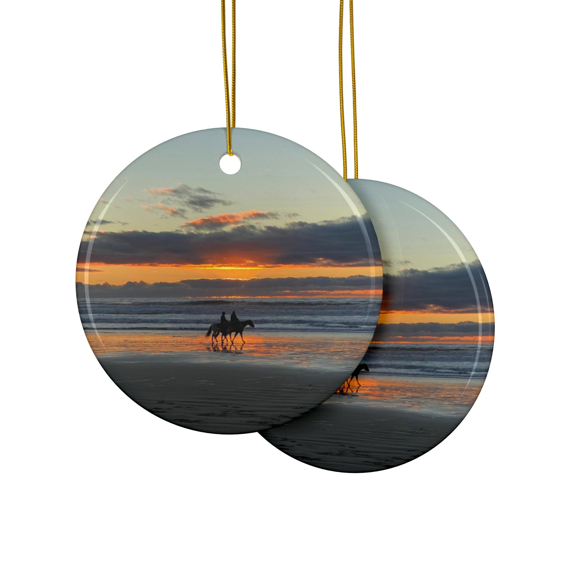 Fron and back side of a ceramic holiday ornament featuring a photograph of two horseback riders silhouetted on a beach at sunset with reflections in the wet sand.