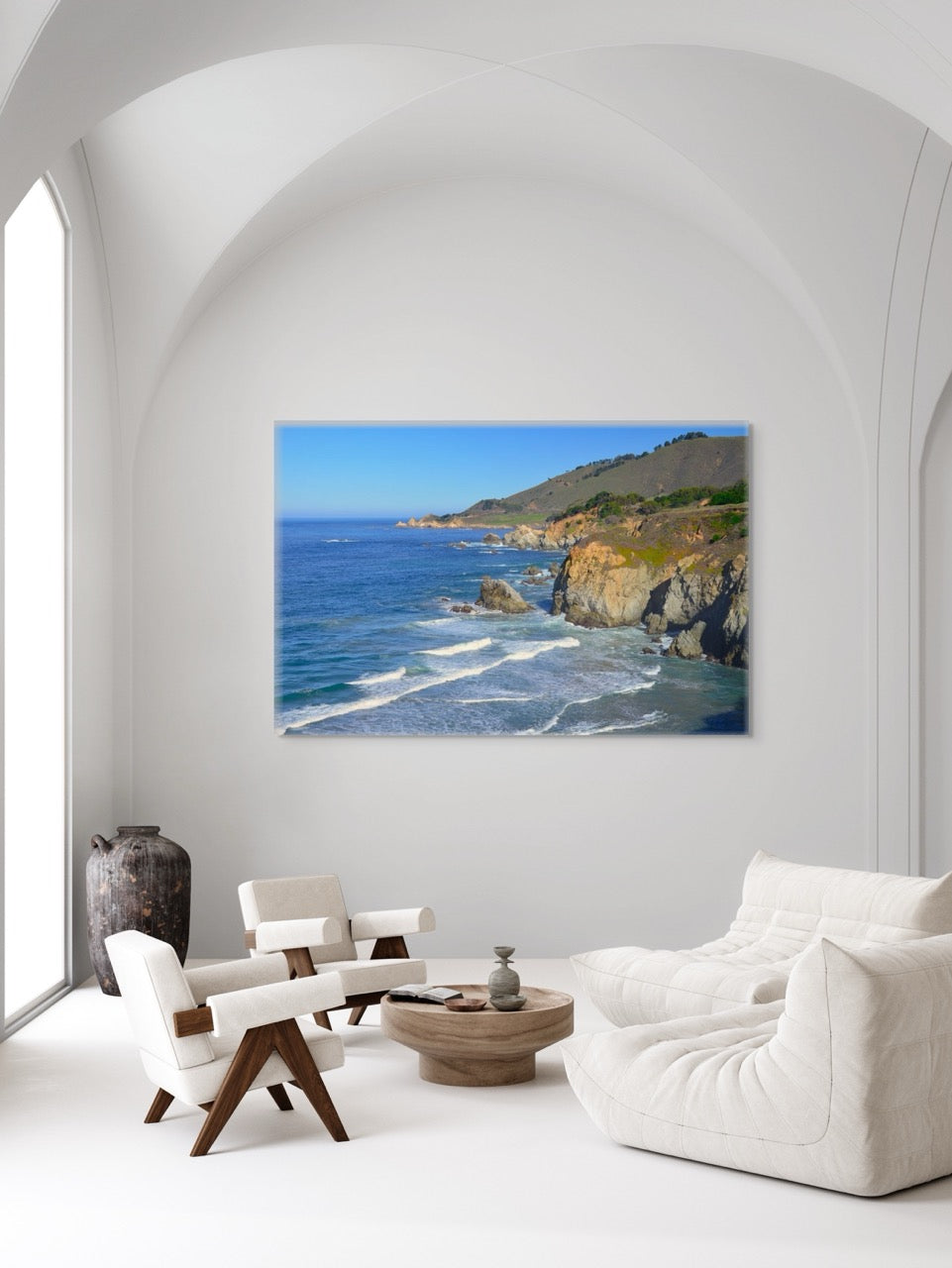 Living room with a large canvas print of the rugged coastline in Big Sur, California.