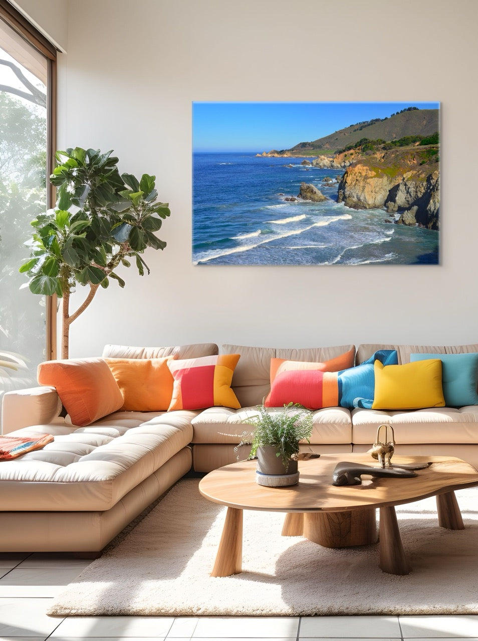 Living room with a sectional sofa, colorful pillows, and a large canvas print of the rugged coastline in Big Sur, California.