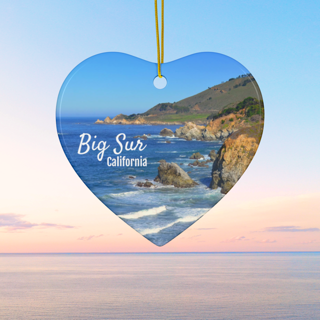 Heart-shaped Ceramic Christmas ornament featuring a photograph of the rugged cliffs and deep blue Pacific Ocean along the Big Sur coastline in California, featuring a beach and ocean.