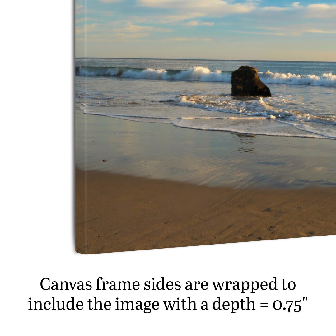 Canvas print of a beach scene with waves and a rock, text indicating frame depth.