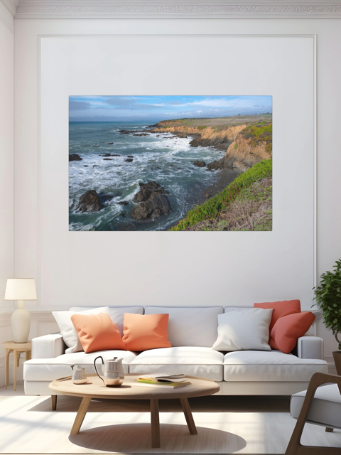 Living room with a large framed picture of a coastal landscape on the wall.