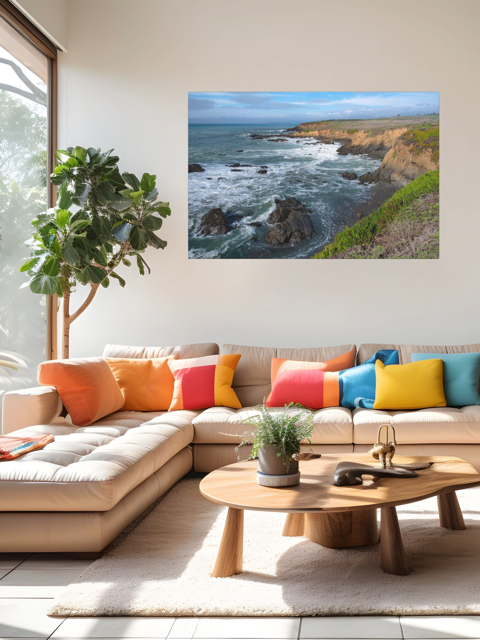 Living room with a sectional sofa, colorful pillows, and a wall art featuring a rugged California coastline.