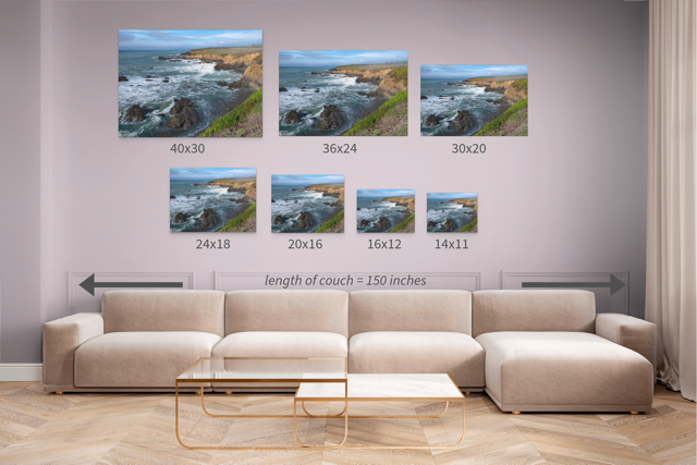 Wall art prints featuring a rugged California coastline with corresponding dimensions displayed above a beige sofa.