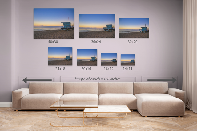 Living room with a beige sectional sofa and canvas prints of a California lifeguard tower at sunrise in different sizes with dimensions listed.