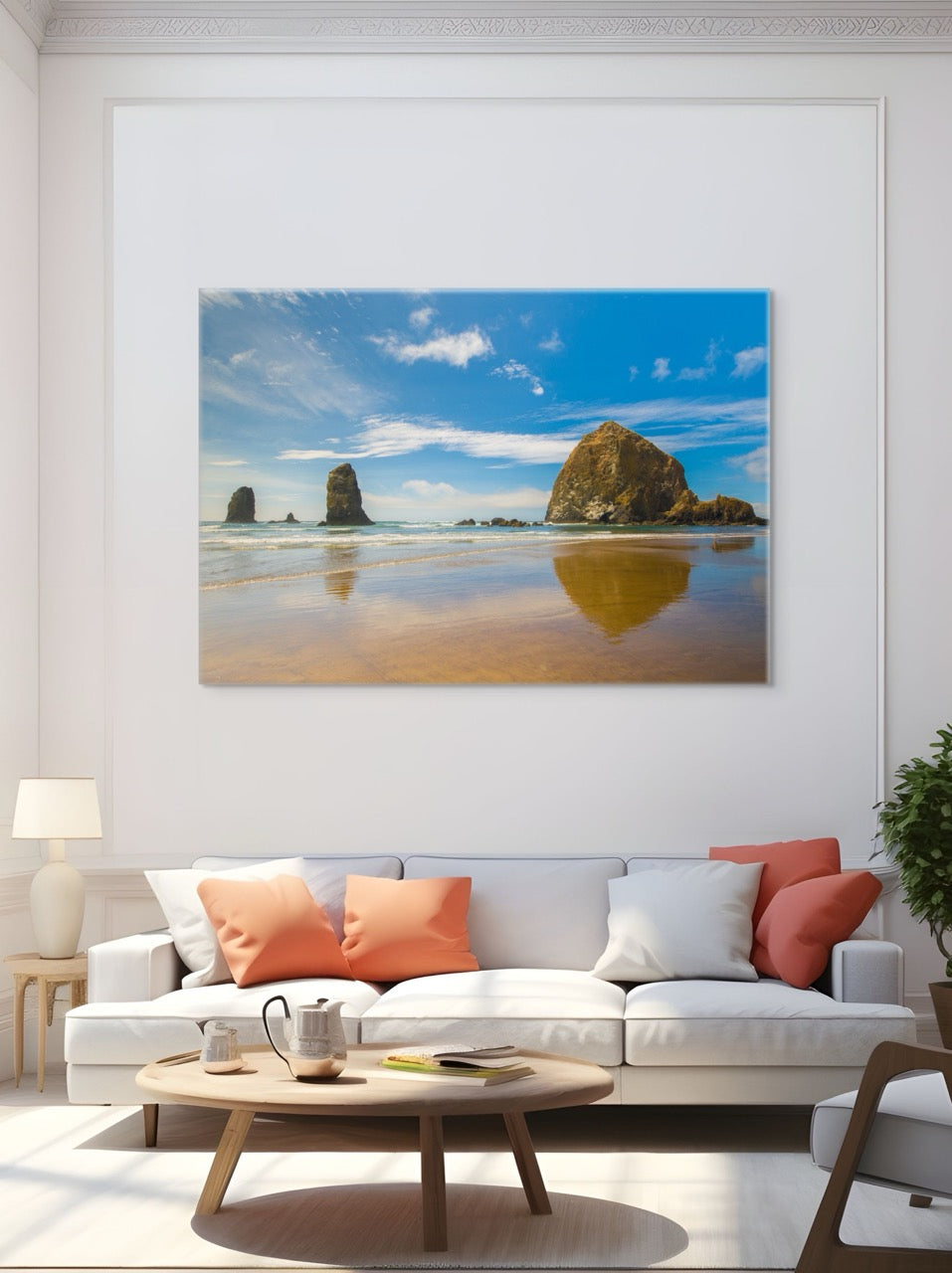 Living room with a white sofa, coffee table, and a large canvas print featuring a view of Haystack Rock and other rock off the coast of Cannon Beach, Oregon.