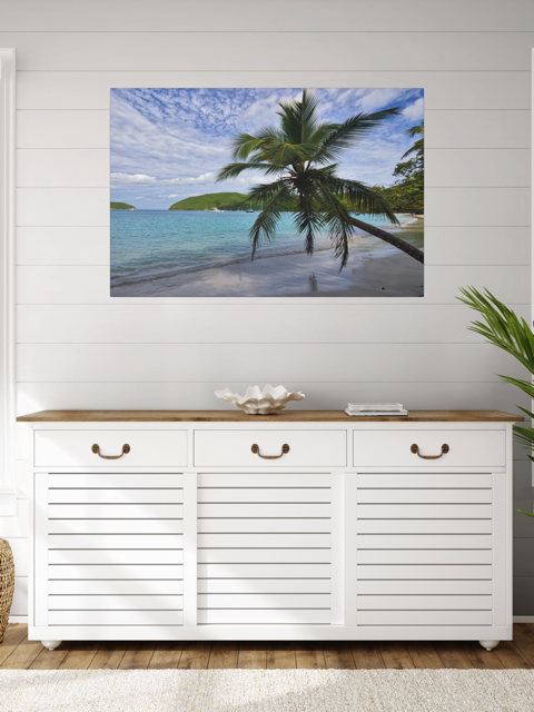 White cabinet with wooden top in a room with a canvas print of a tropical beach scene on the wall.