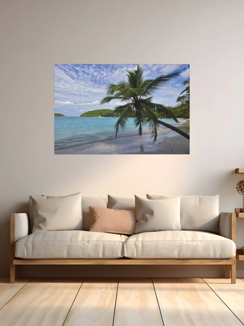 Sofa with a canvas print of a tropical beach scene on the wall