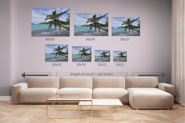 Living room with a beige sectional sofa  and seven identical canvas prints of a tropical beach scene displayed in different sizes.