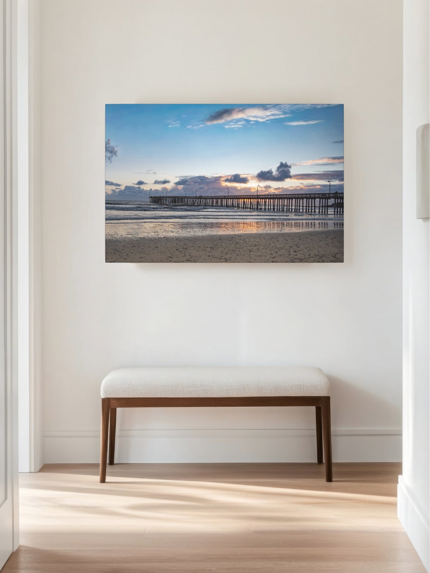 Cayucos Pier sunset canvas print on a wall above a wooden bench