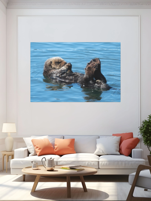 A sea otter in water on a wall art print above a living room sofa with colorful pillows.