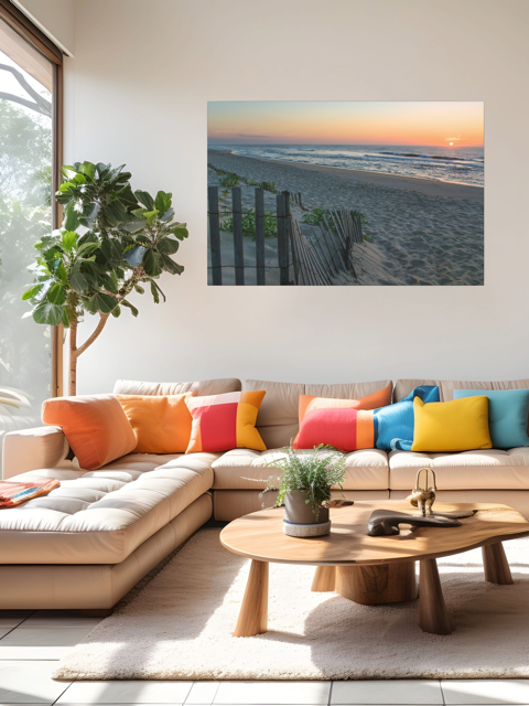 Modern living room with a sectional sofa, colorful pillows, and a canvas print of a coastal sunrise on a sandy beach with a weathered wooden fence on the wall.