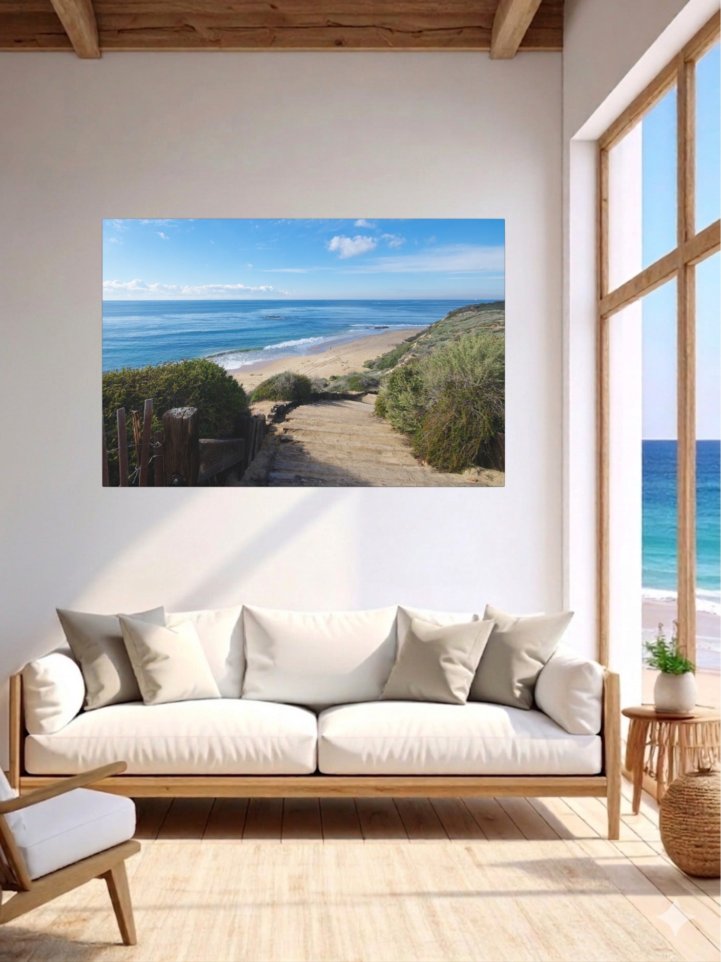 Living room with a lcanvas print of the wooden stairs leading to Crystal Cove State Beach in Orange County California on the wall above a sofa.