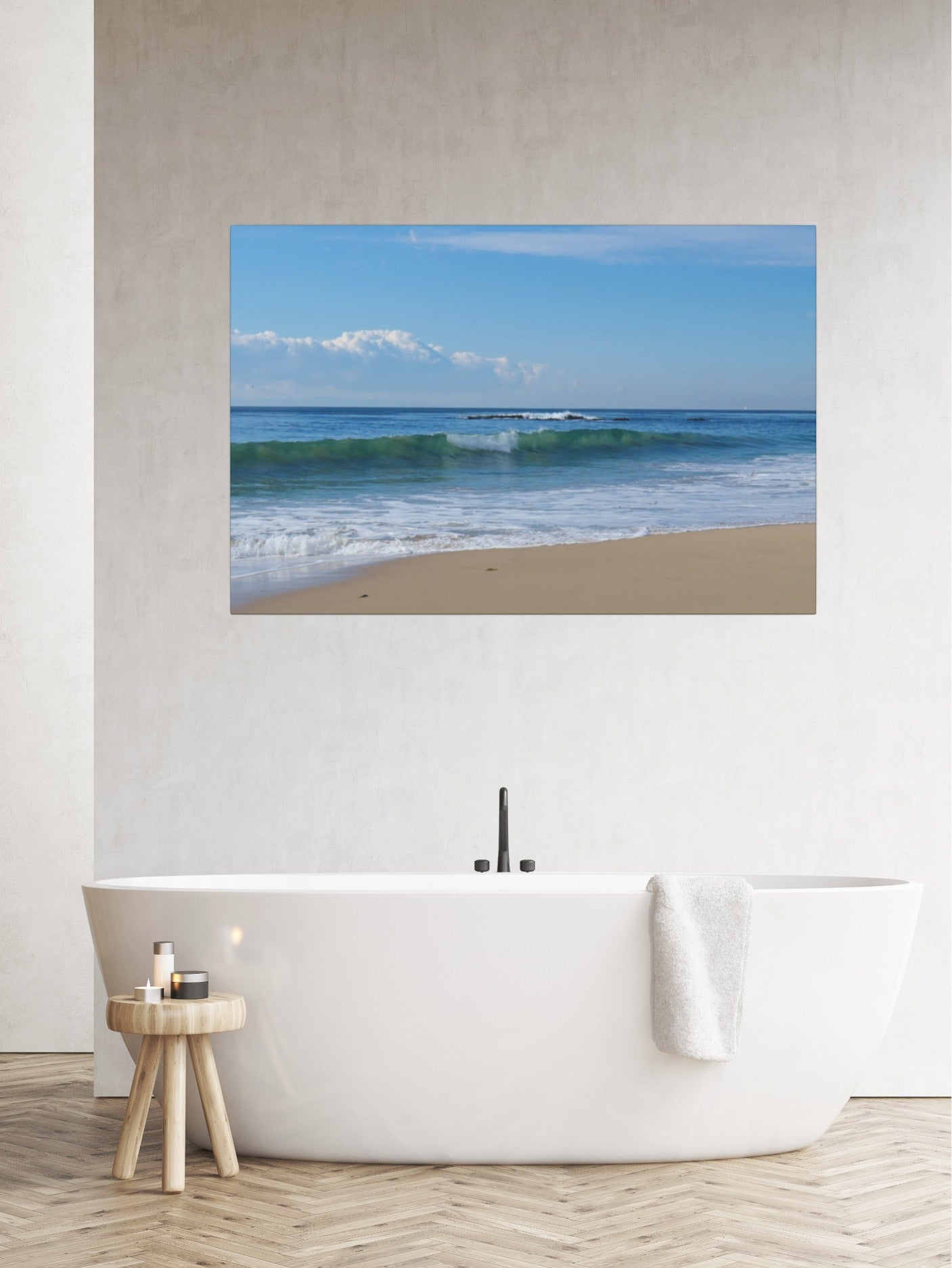 Crystal Cove State Beach breaking wave with translucent green water canvas print on a wall above a white bathtub in a bathroom.