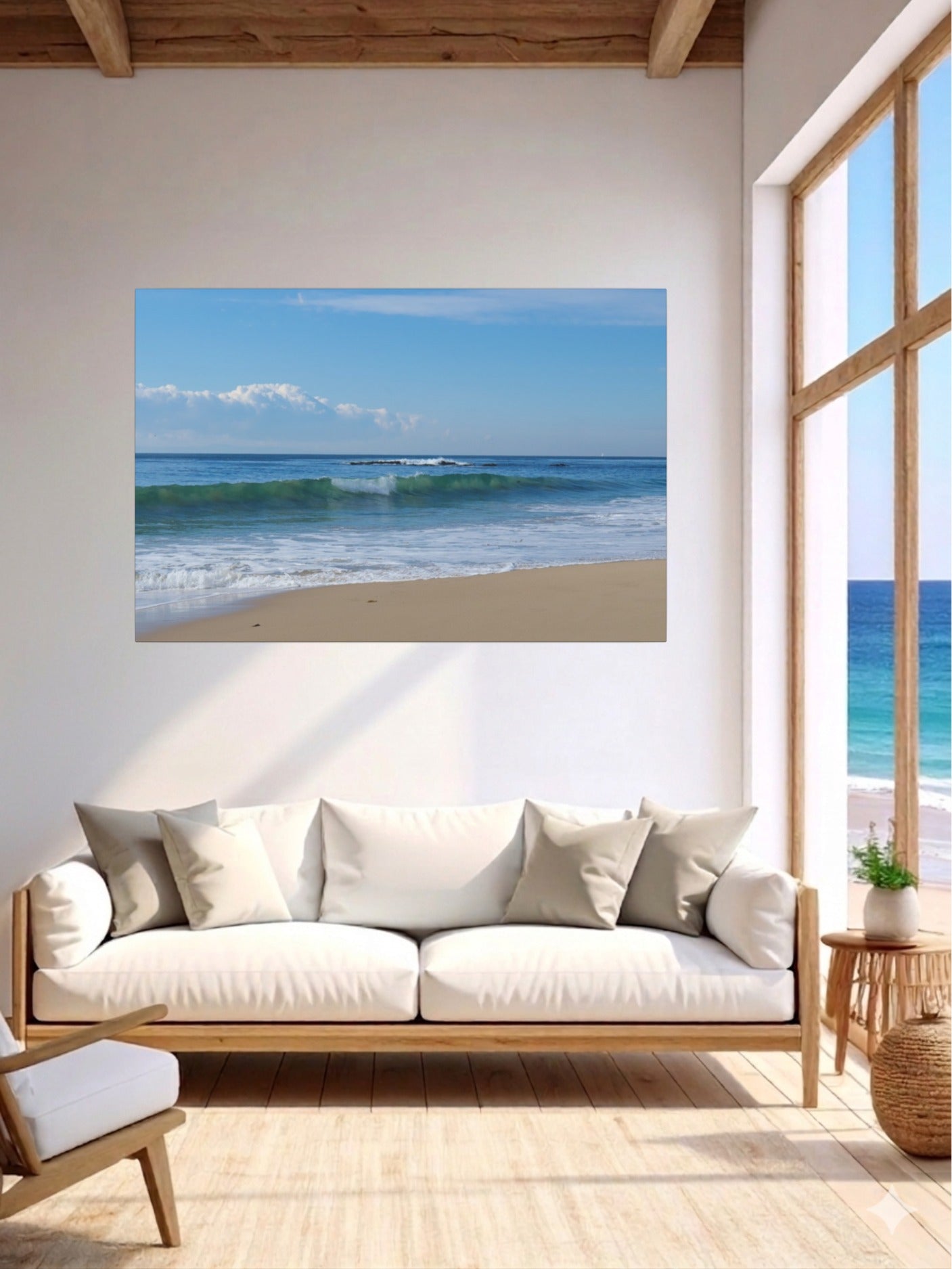 Living room with a lCrystal Cove State Beach breaking wave with translucent green water canvas print, white sofa, and wooden floor.