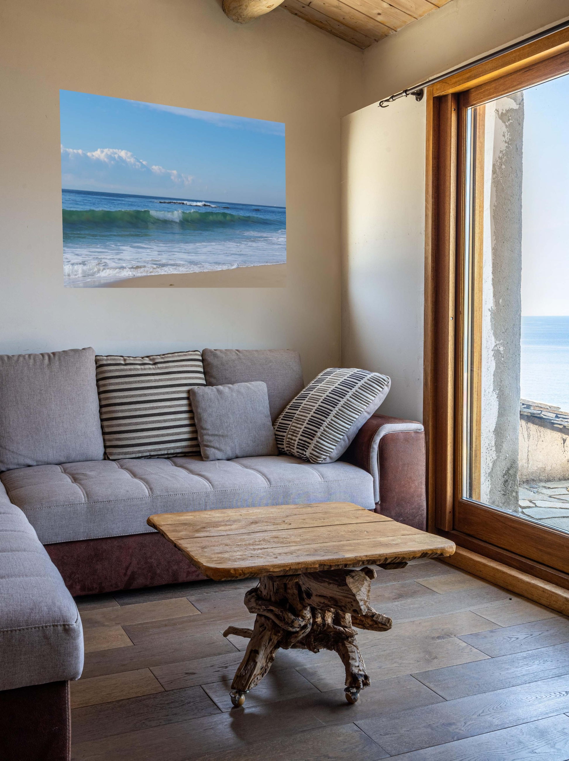 Living room with a gray sofa, wooden coffee table, and a Crystal Cove State Beach breaking wave with translucent green water canvas print.