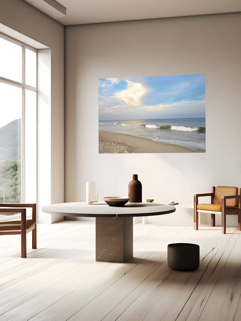 Modern interior with a round table and chairs, featuring a large canvas print of a wide-angle view of the Jersey Shore beach at early evening with rolling ocean waves and a bright, cloudy sky on the wall.
