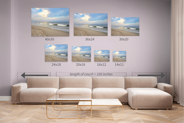 Living room with a beige sectional sofa and seven canvas prints depicting the same beach scenes with different dimensions.