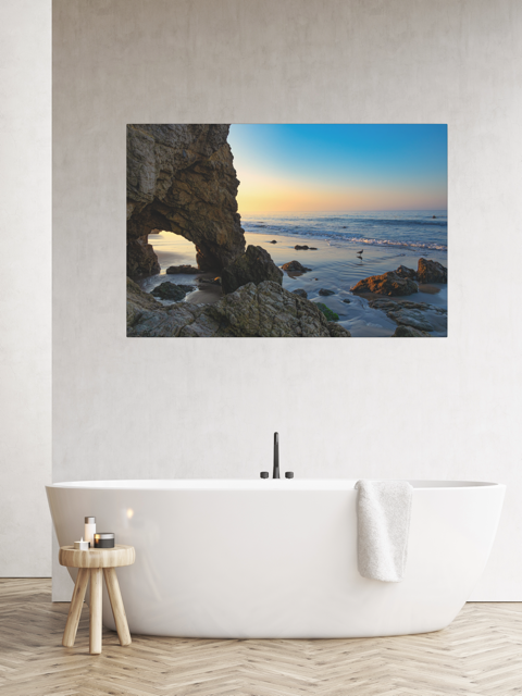 Bathroom with a canvas print of a sea cave at sunrise in Malibu.