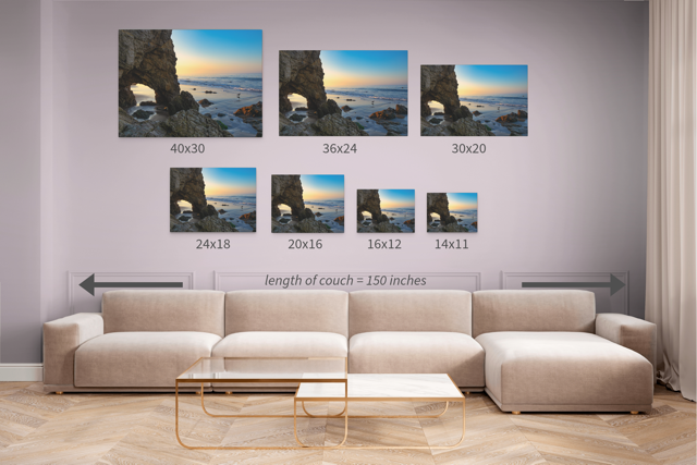 Living room with a beige sectional sofa and canvas prints of a sea cave at sunrise in Malibu in various sizes.