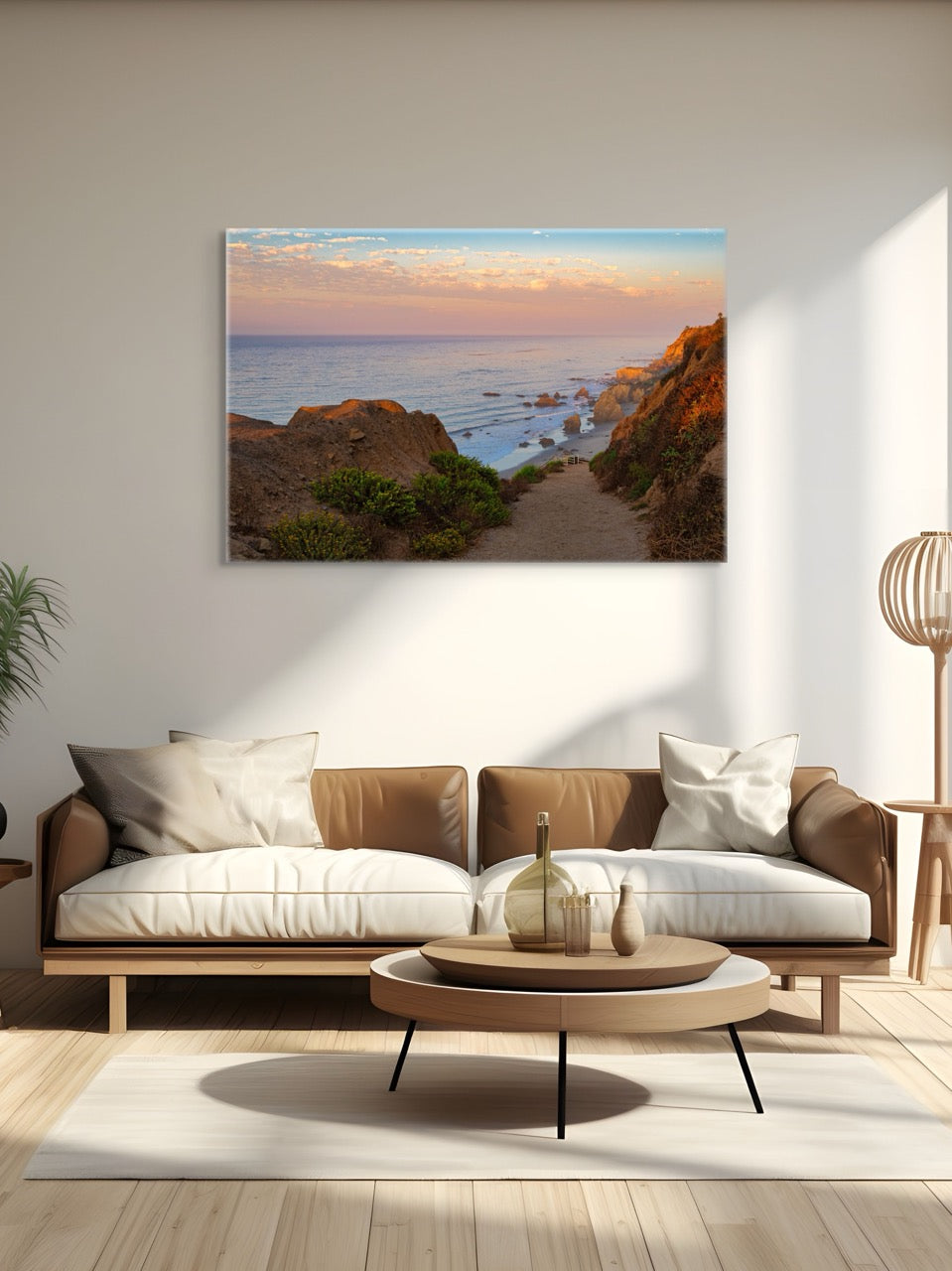 Modern living room with a couch, coffee table, and wall art of a coastal scene.