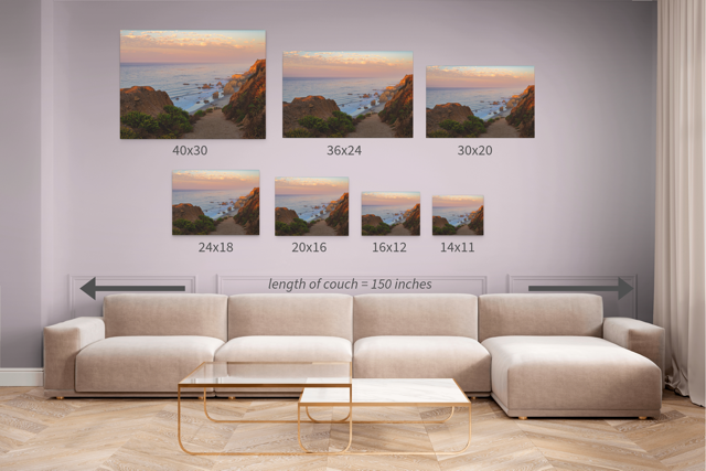 Living room with a beige sectional sofa and coffee table, featuring wall art prints of a coastal scene.