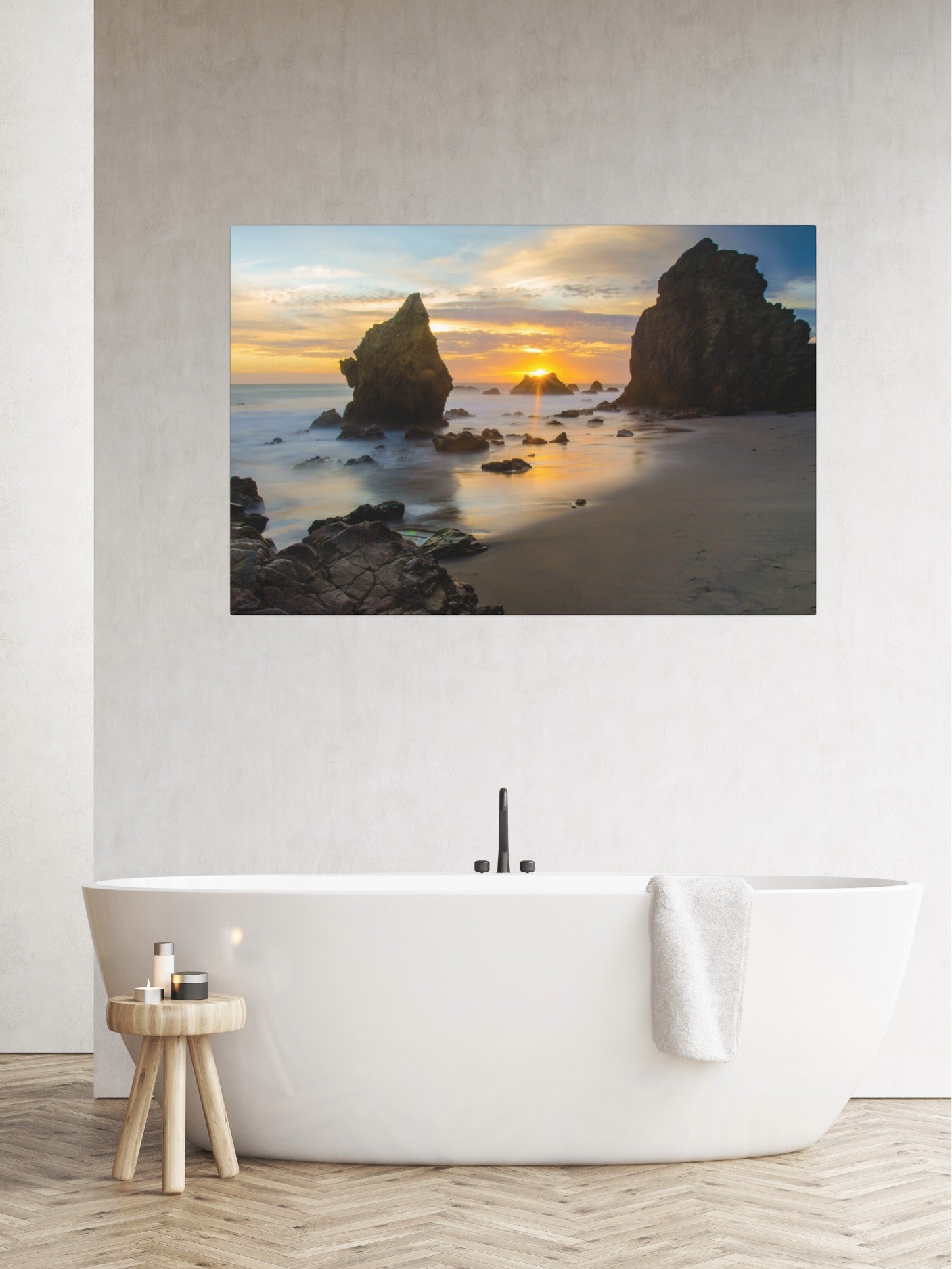 El Matador State Beach winter sunset with dramatic sea stacks and golden sunburst canvas print on a wall above a white bathtub.