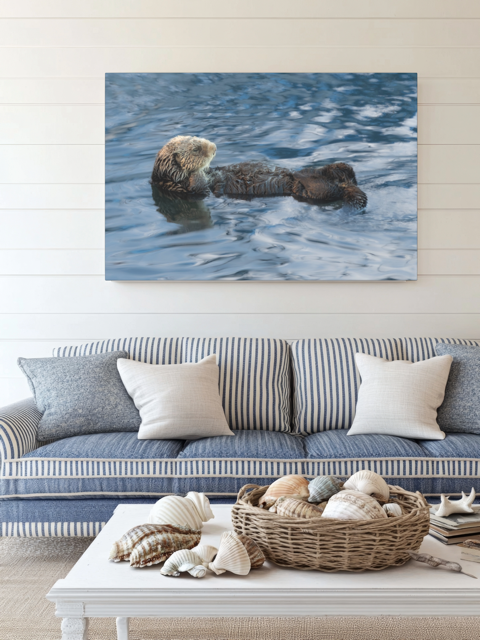 Living room with a sea otter canvas print above a striped sofa.