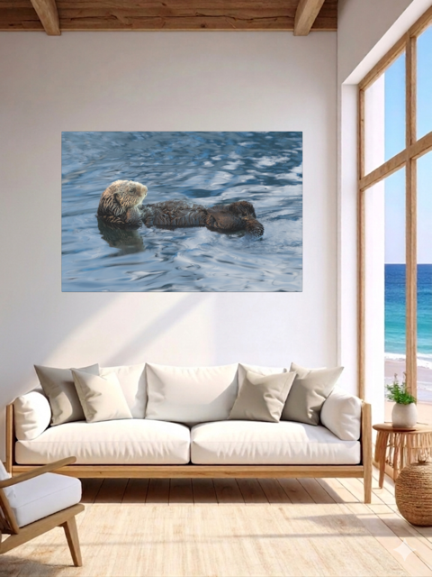 Living room with a sea otter canvas print, a white sofa, and a large window.