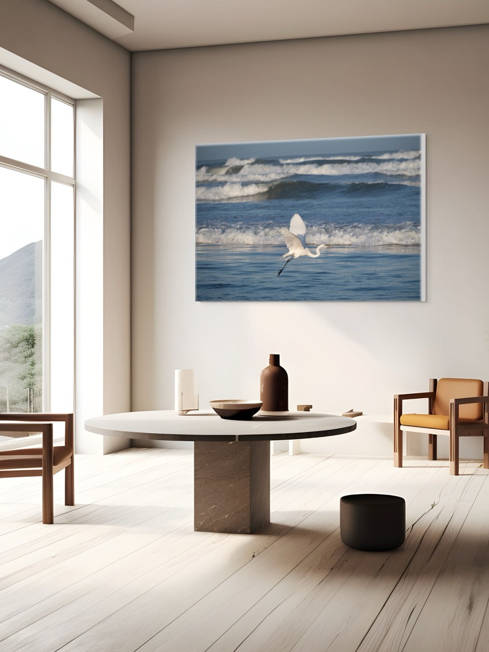 Modern living room with a large canvas print of a white egret in flight over the ocean on the wall.