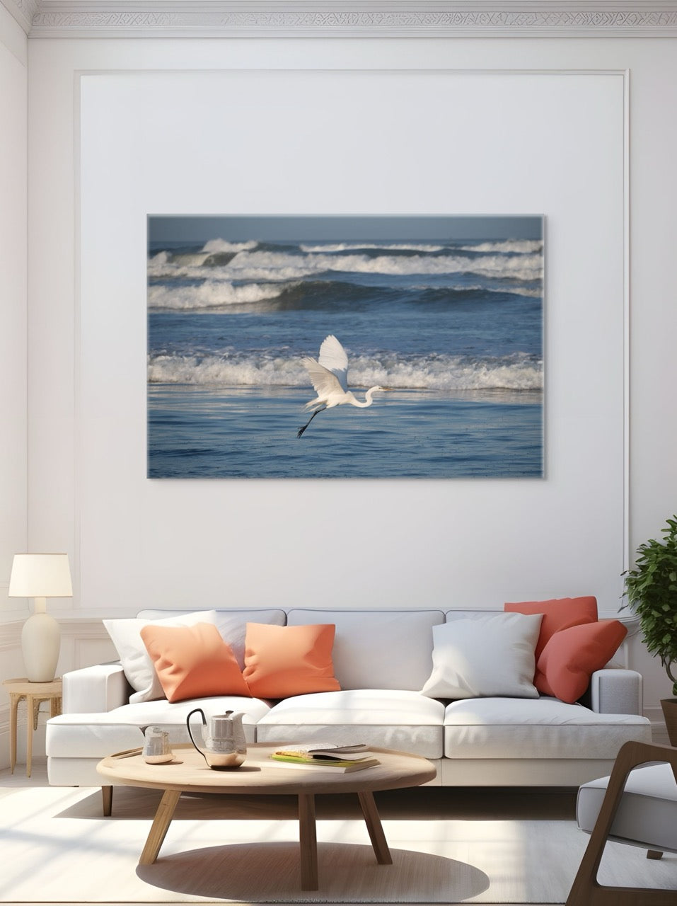 Living room with a large canvas print of a white egret in flight over the ocean on the wall.