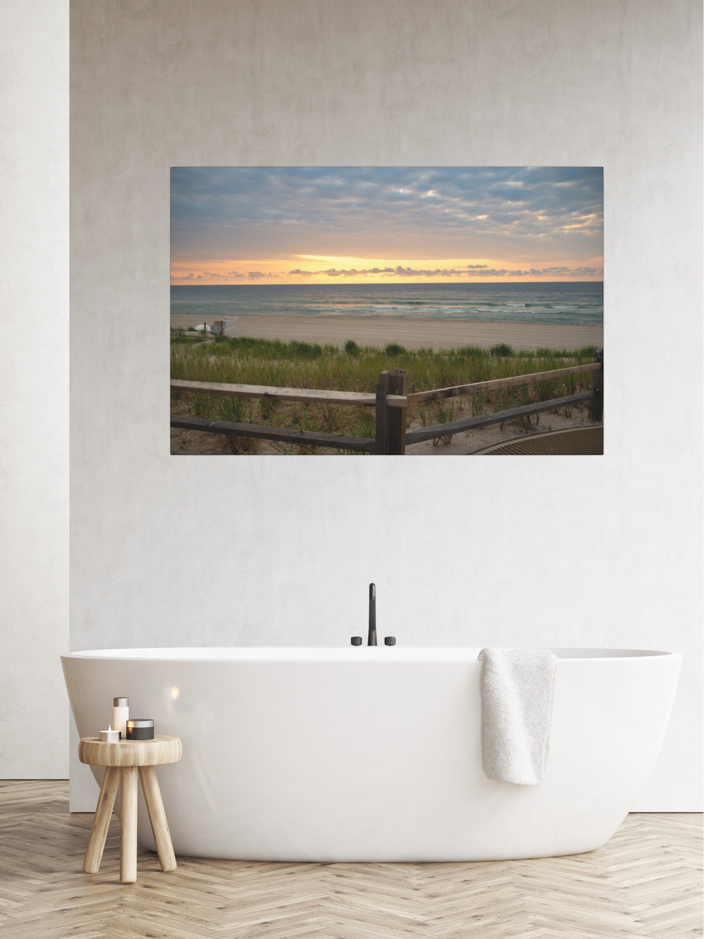 Canvas print of a Jersey Shore sunrise over the Atlantic Ocean with beach dunes and grasson a wall above a white bathtub in a bathroom.
