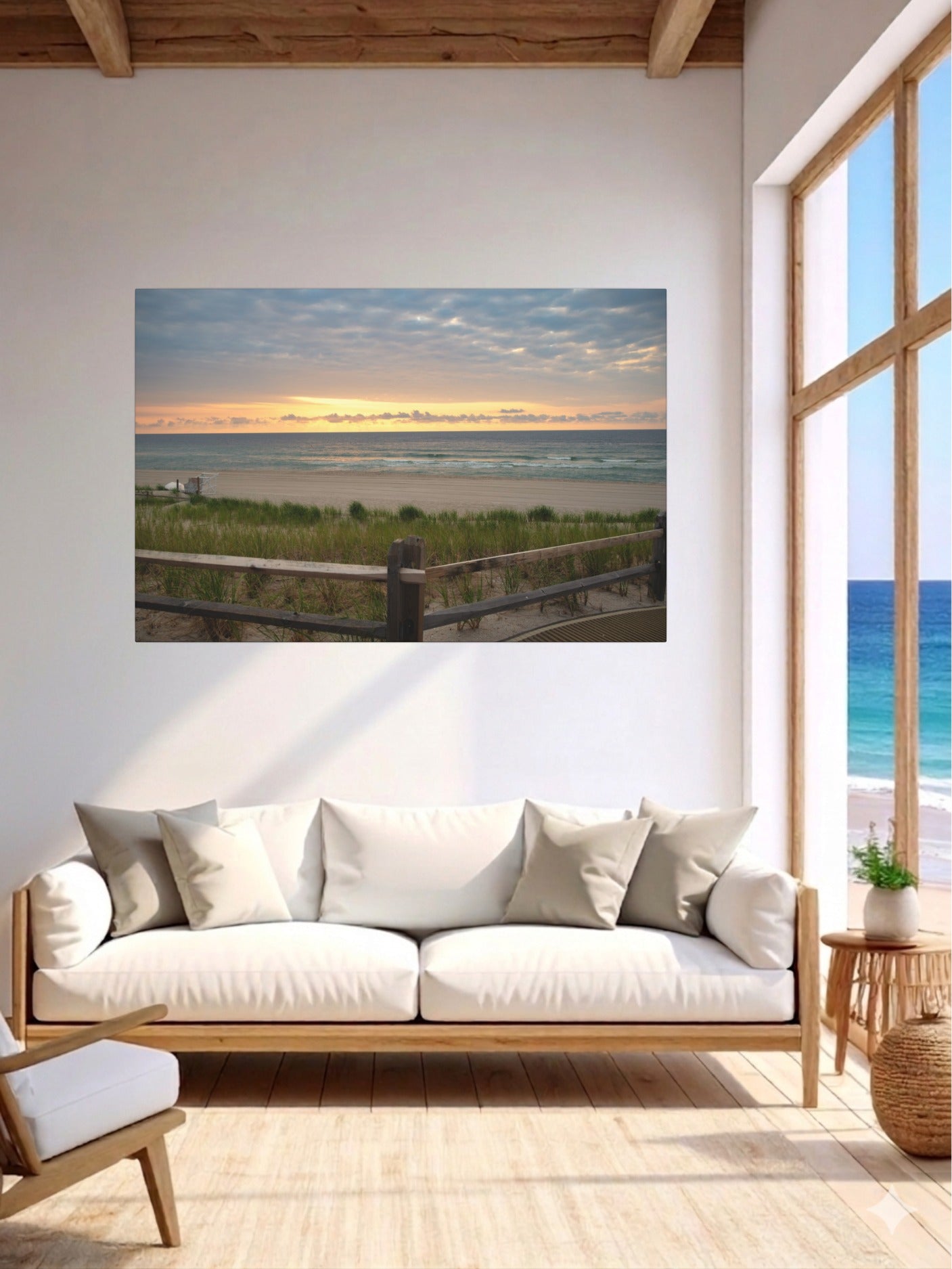 Living room with a large window and a sofa, featuring a canvas print of a Jersey Shore sunrise over the Atlantic Ocean with beach dunes and grass.