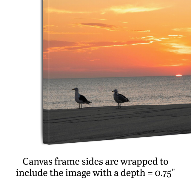 Side view of a canvas print of two seagulls standing on a sandy Jersey Shore beach during a vibrant orange sunrise over the Atlantic Ocean demonstrating frame depth.