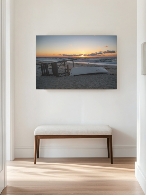 Canvas print of a Jersey Shore sunrise on a wall above a wooden bench with a white cushion.