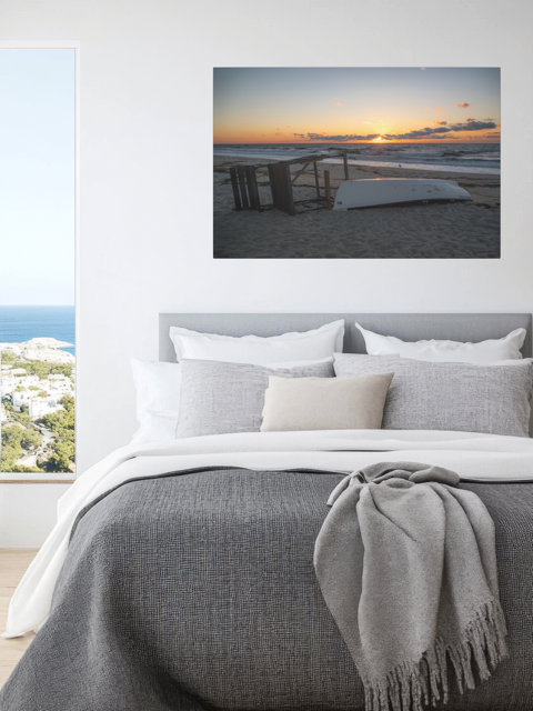 Bedroom with a canvas print of a Jersey Shore sunrise above the bed.