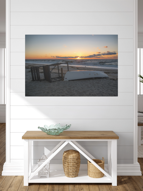 Canvas print of a Jersey Shore sunrise on a wall above a wooden console table with decorative items.
