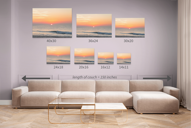 Wall art prints featuring a summer sunrise over the Atlantic Ocean as seen from a quiet beach on the Jersey Shore with corresponding dimensions displayed above a beige sofa.