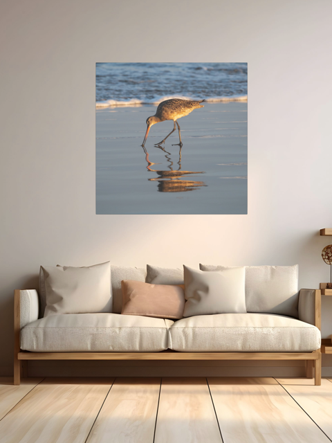 Sofa with a canvas print of a long-billed curlew on the shoreline above it