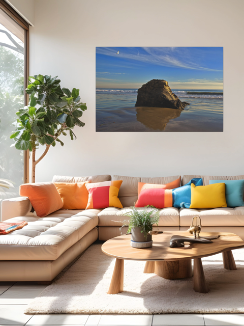 Modern living room with a sectional sofa, colorful pillows, and a beach scene canvas print on the wall.