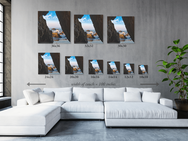 White sectional sofa with wall art displaying various sizes of prints on a gray wall.