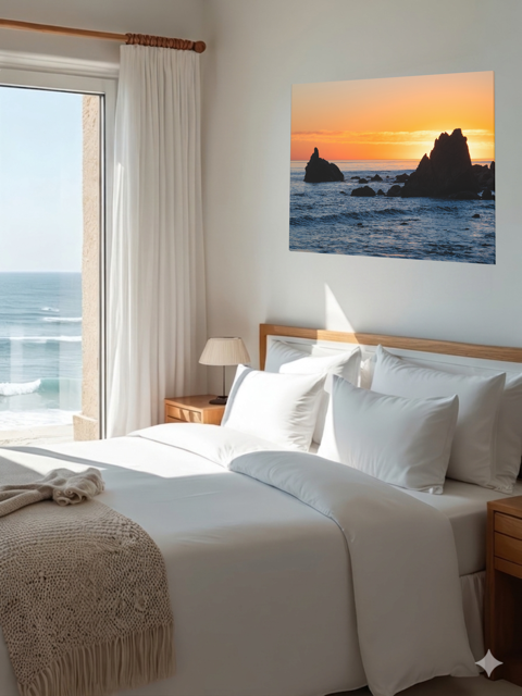 Canvas print of an ocean sunset with rocks over a bed.