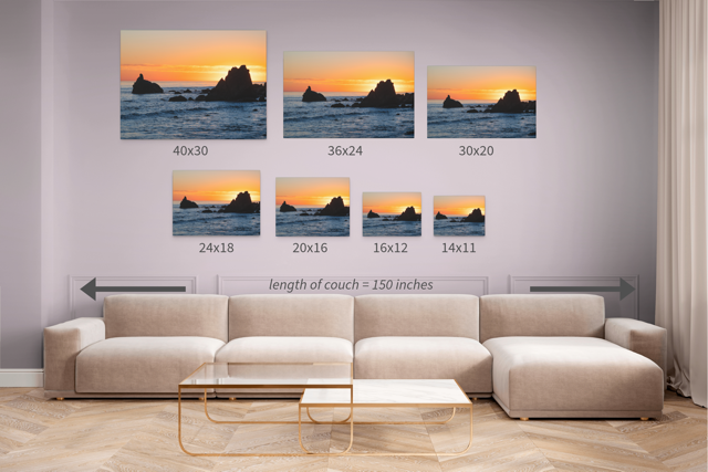 Wall art prints of a sunset over water displayed above a sofa with dimensions indicated.