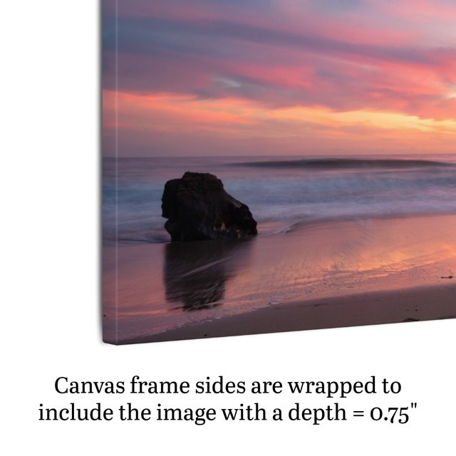 Side view of a canvas print of a solitary rock sea stack on a Malibu beach at sunset with a vibrant pink, orange, and purple sky reflected in the wet sand, text indicating frame depth.
