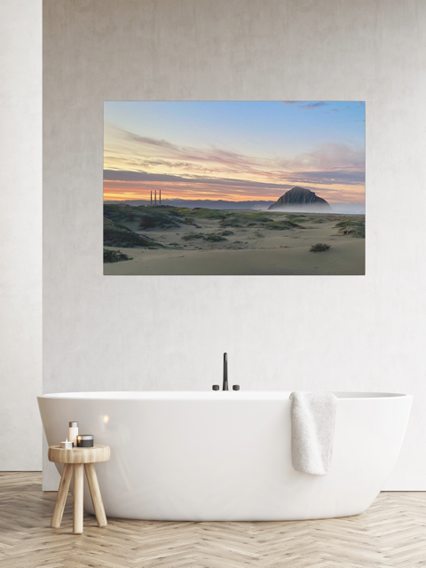 Vibrant sunrise over Morro Rock and Three Stacks from beach dunes canvas print above a white bathtub.